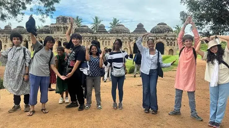 MUWCI students raising their hands together on a Triveni trip